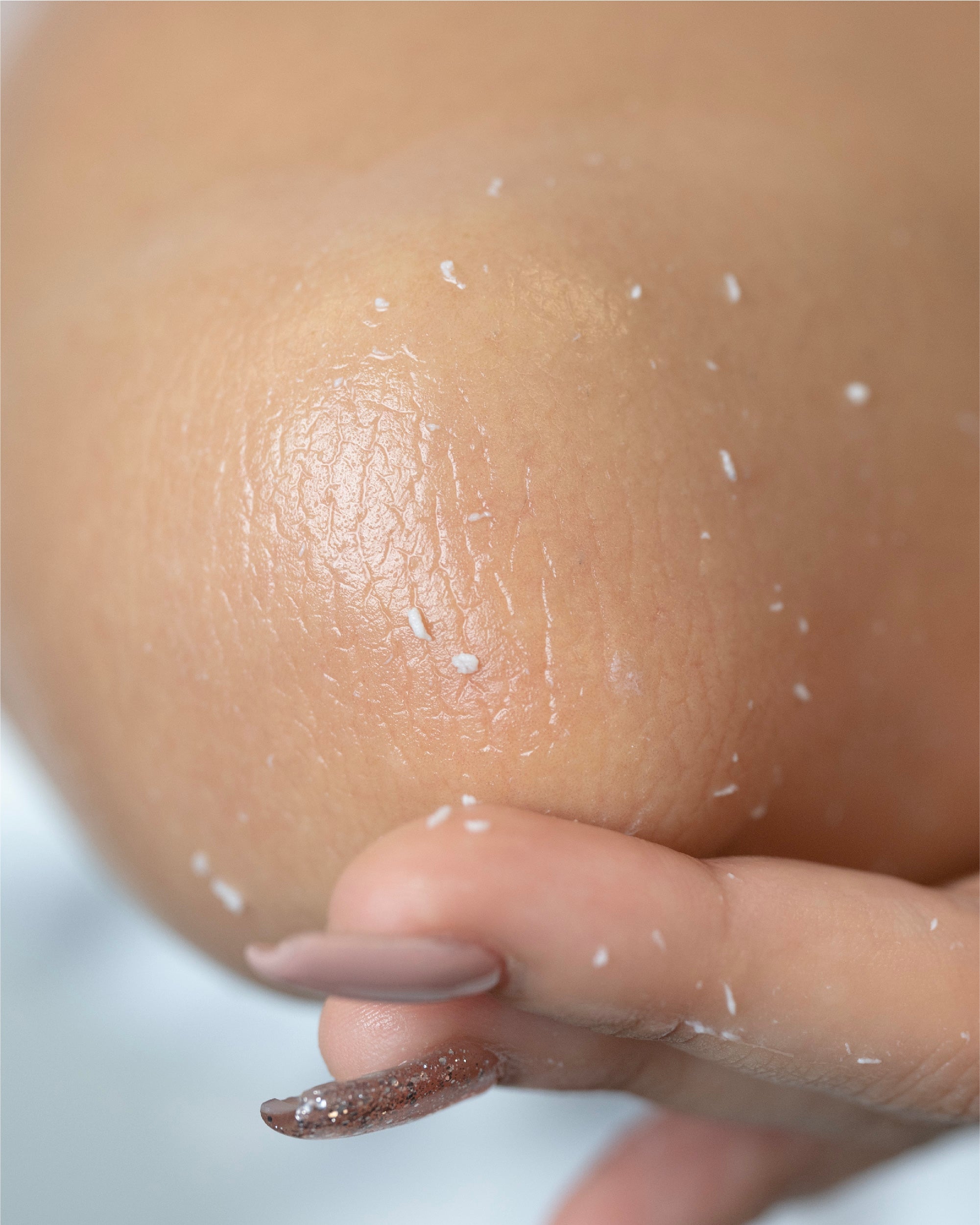 gentle exfoliator reacts to dead skin cells and turns to white beads on elbow