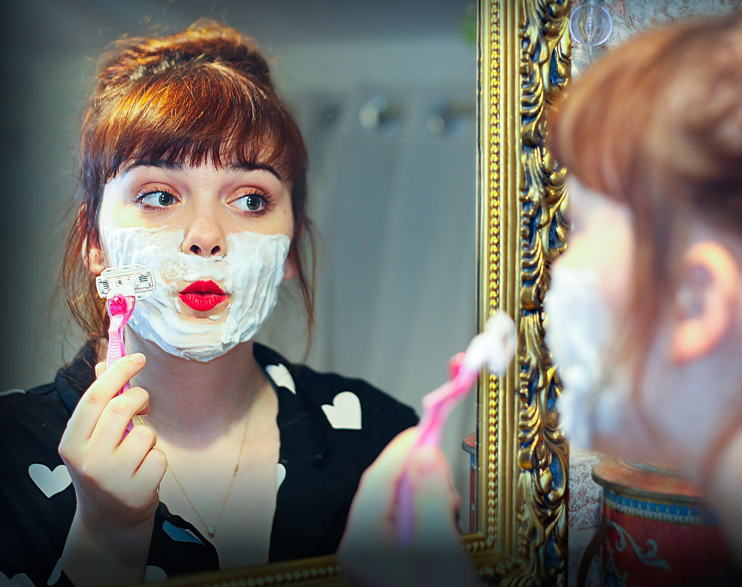 a woman shaving her face