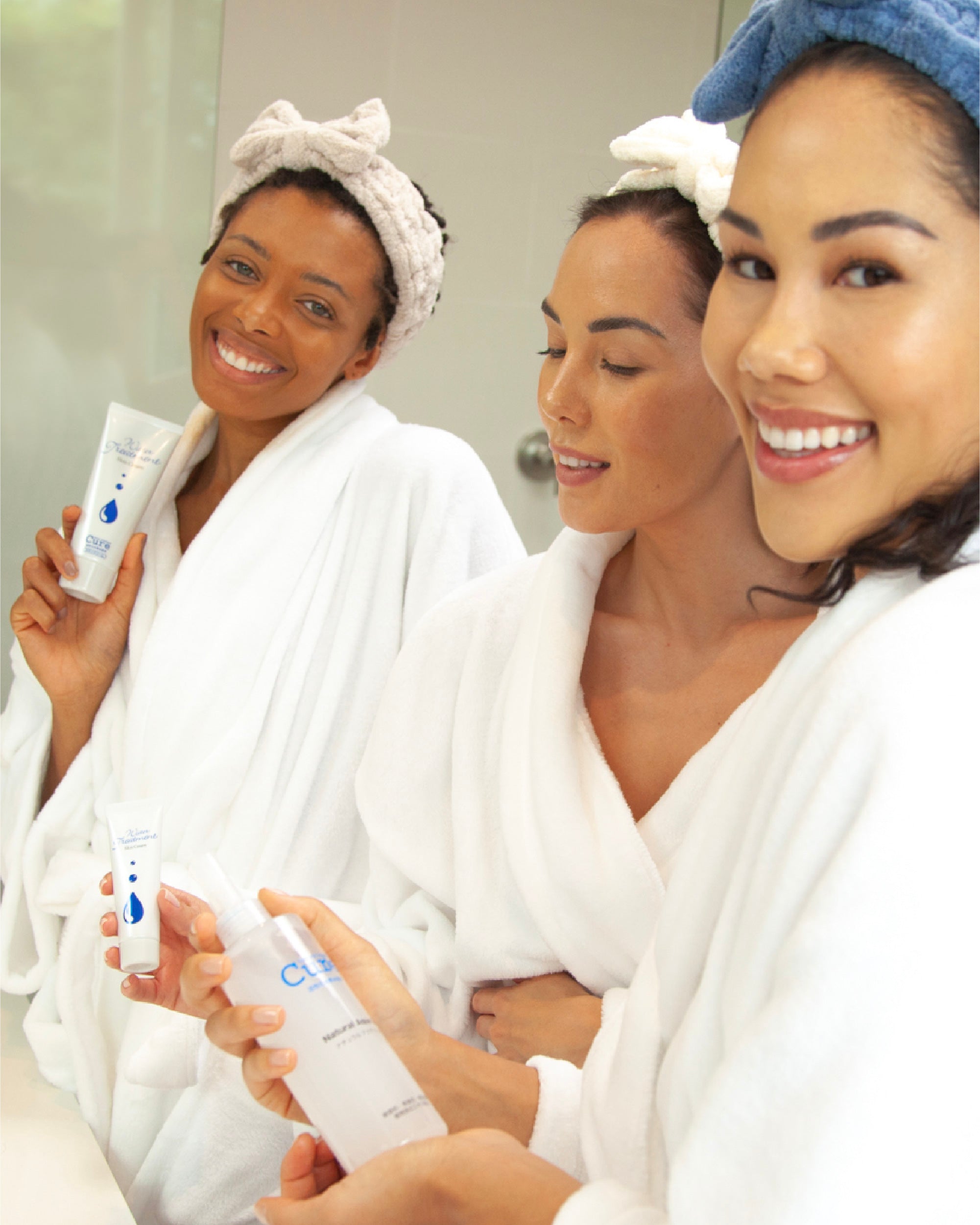 3 females smile with aqua gel exfoliator and water treatment moisturizer