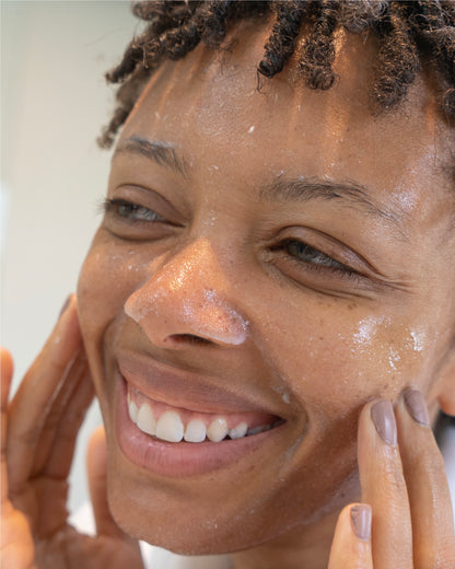 female apply water-based exfoliator on her face